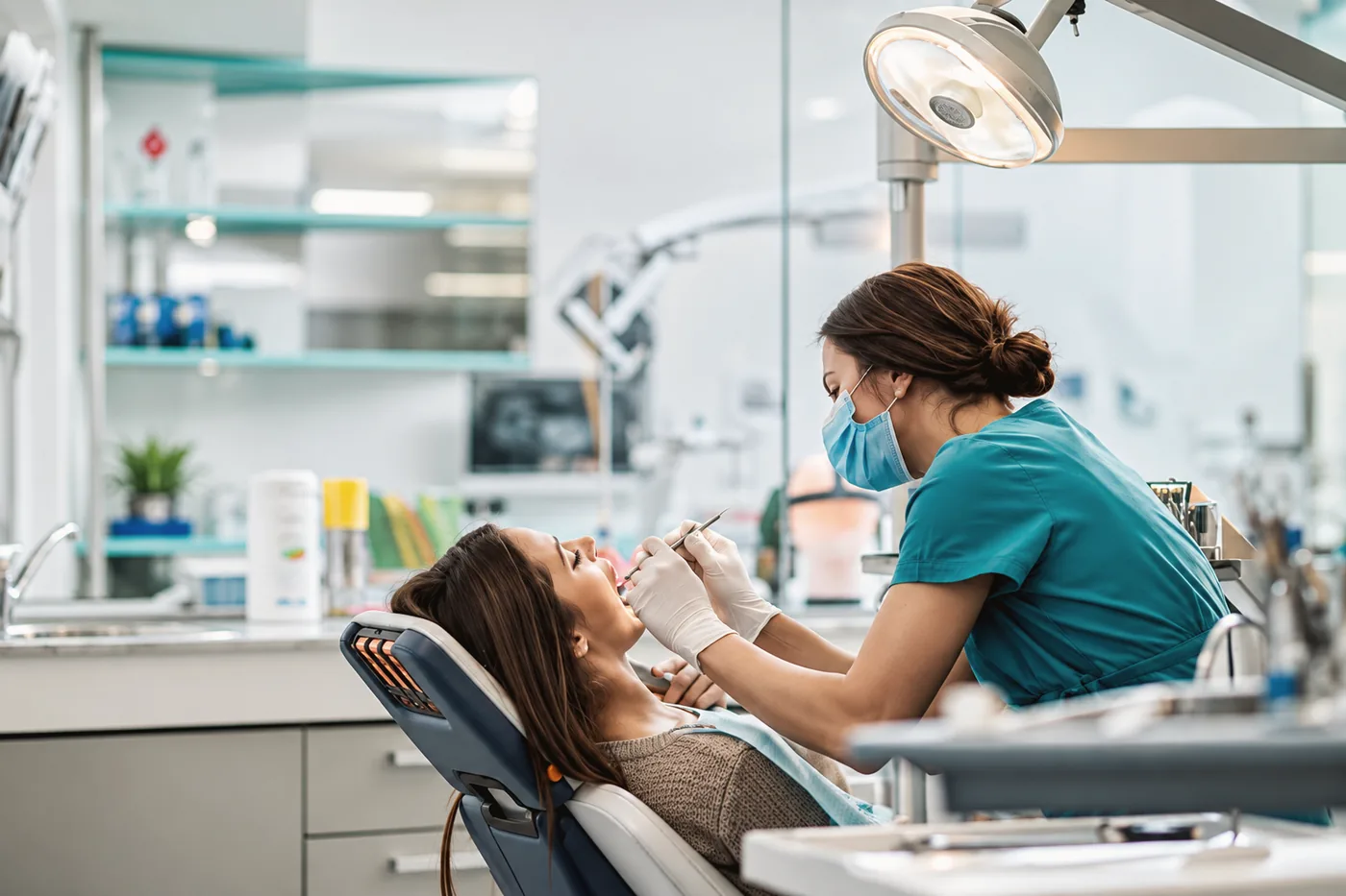 A clinician carrying out a check-up in a bright treatment room
